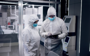 Two Workers Looking At Tablet In Semiconductor Manufacturing