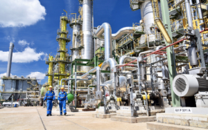 Two Workers Walking Through Refinery