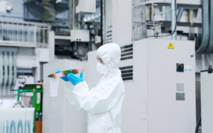 Worker Inspeting Semiconductor Wafer