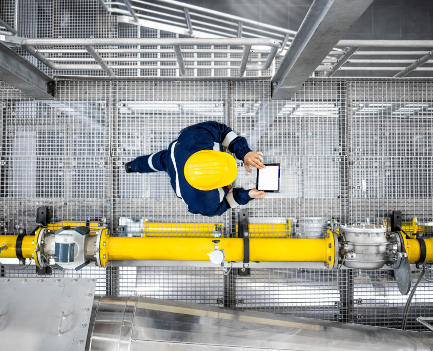 Worker With Tablet Walking Through Refinery